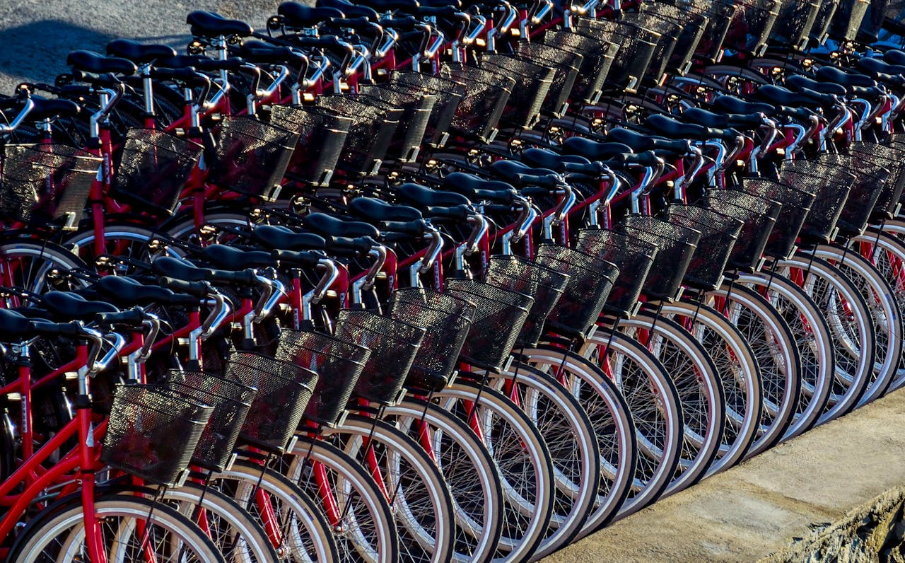 A neat row of red bicycles parked in Stockholm ready for cyclists.