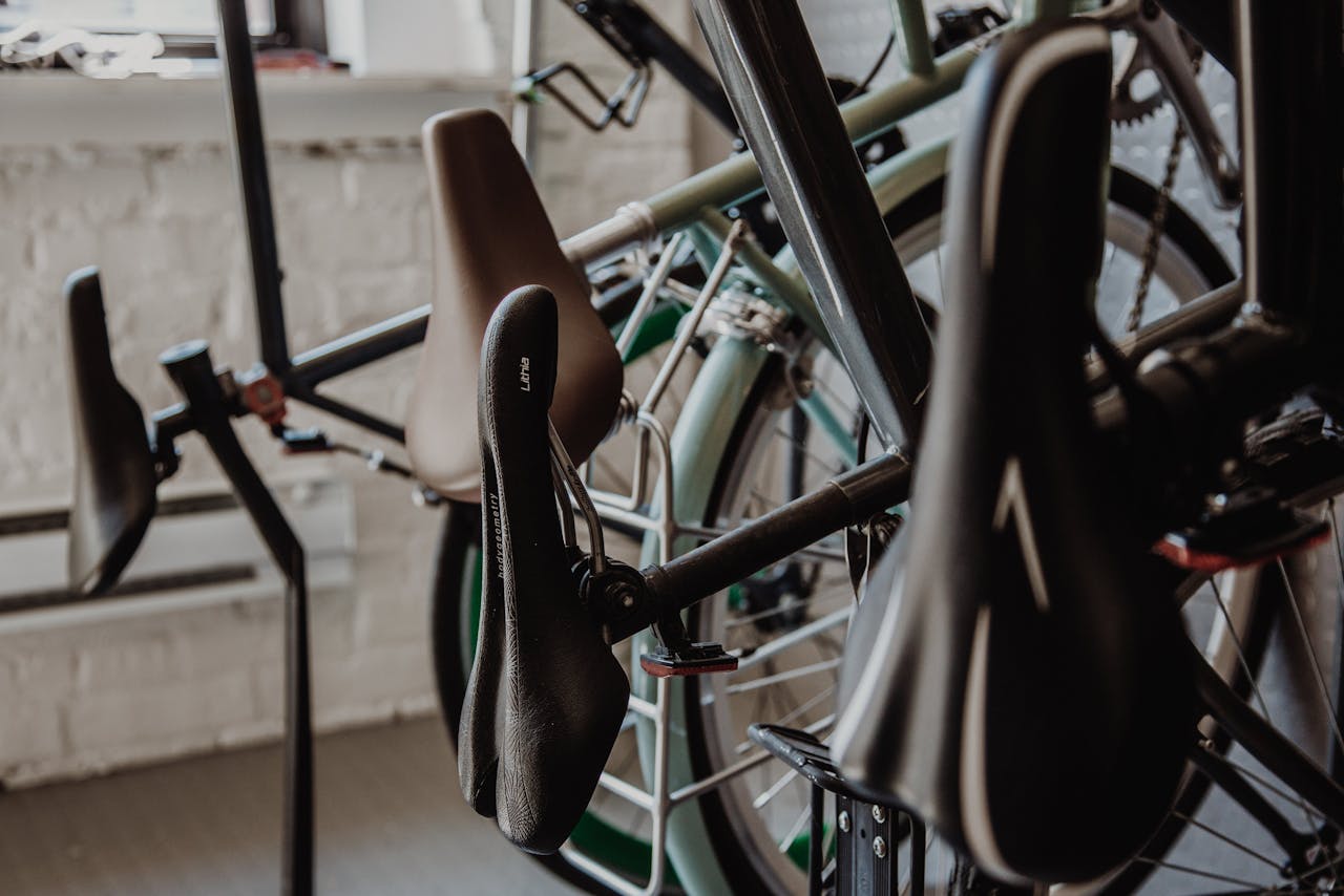 Home Close-up view of bicycle seats and wheels in an indoor shop setting. Ideal for transportation and bicycle-related themes.